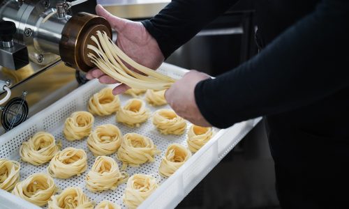 Man working with Pasta manufacture machine